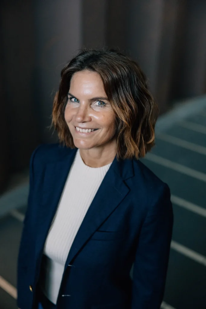 Portrait of Mathilde Holmer smiling in a navy blazer